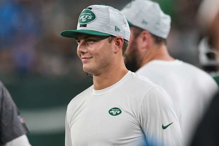 Jets QB Zach Wilson smiling on sideline